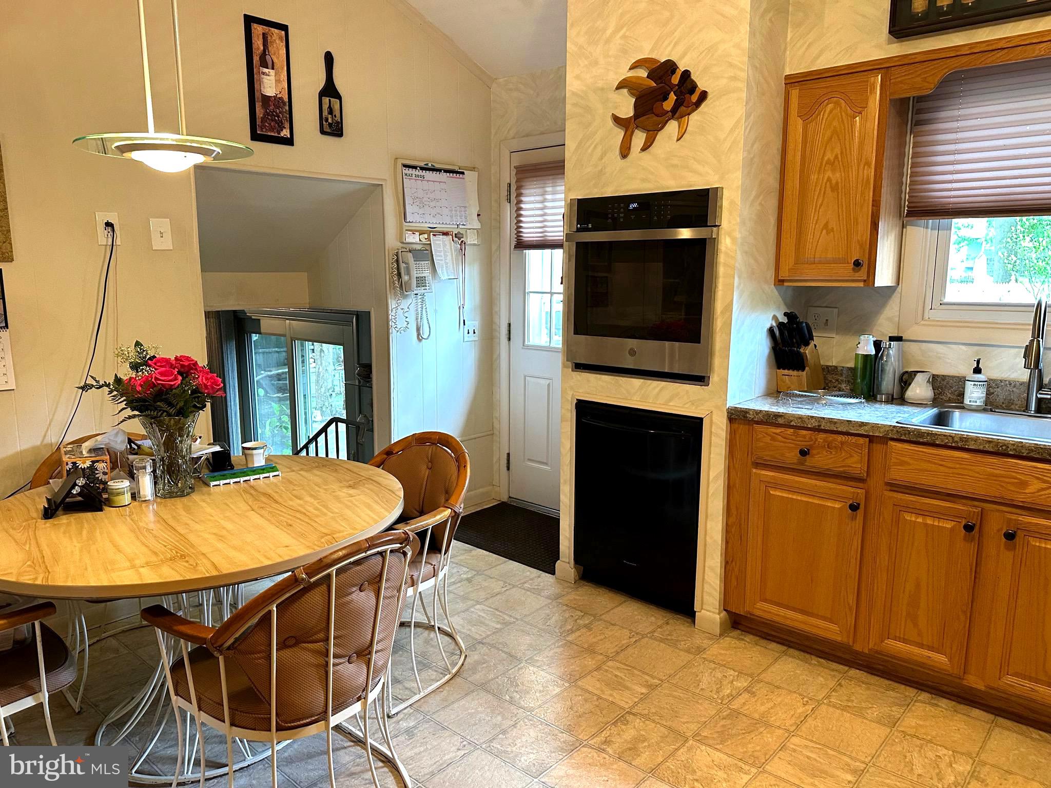 901 Kingston Drive Cherry Hill, NJ 08034 - Photo 12 of 30 a kitchen with stainless steel appliances wooden floor and dining table