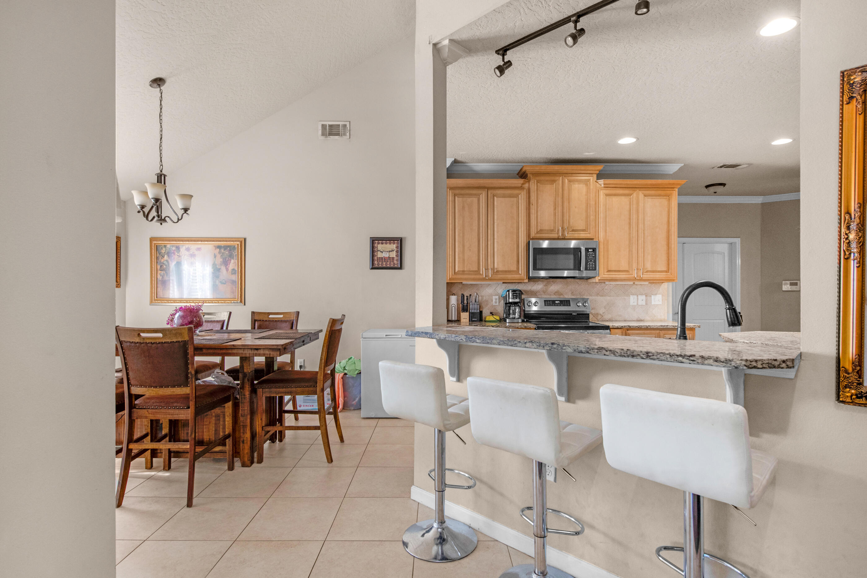 4537 Annabelle Lane Crestview, FL 32539 - Photo 11 of 41 a kitchen with kitchen island granite countertop a table and chairs in it