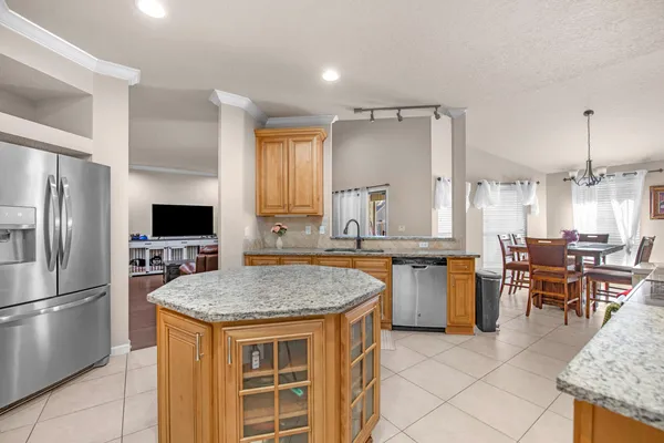 a kitchen with a sink refrigerator and cabinets