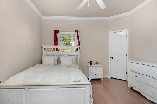 a room with a bed and a dresser