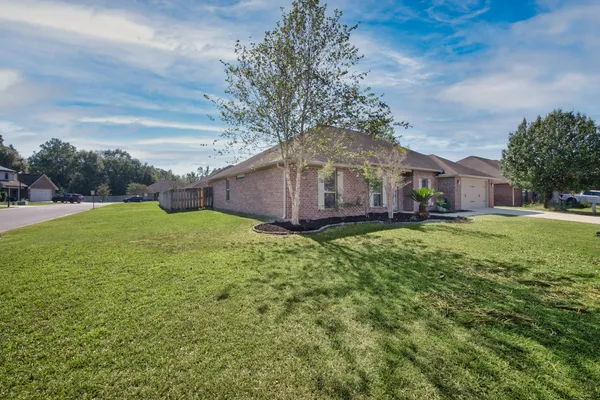 a front view of house with yard and green space
