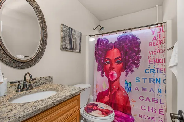 a bathroom with a granite countertop sink mirror and vanity