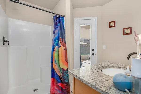 a bathroom with a granite countertop tub and a sink