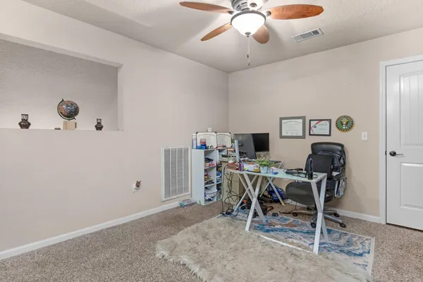 a workspace with a table and chairs