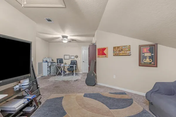 a room with furniture and a flat screen tv