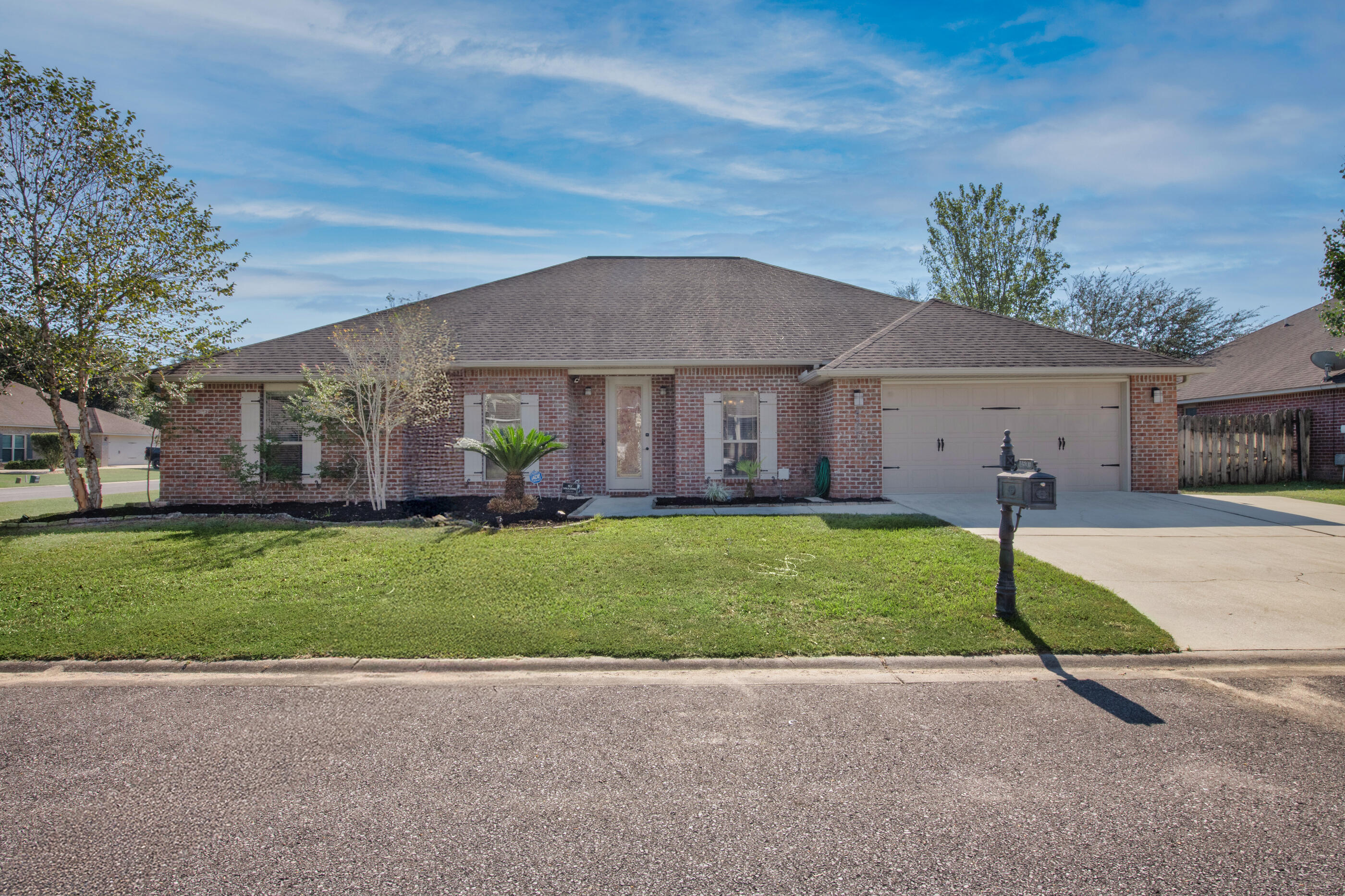 4537 Annabelle Lane Crestview, FL 32539 - Photo 41 of 41 a front view of a house with a garden and plants