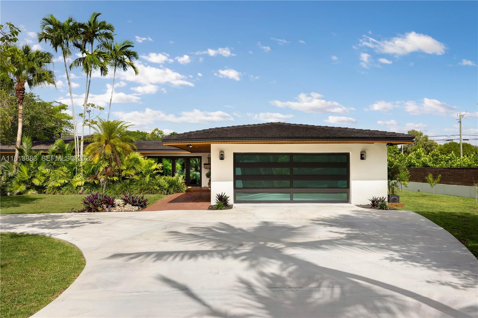 a front view of a house with a garden and a yard
