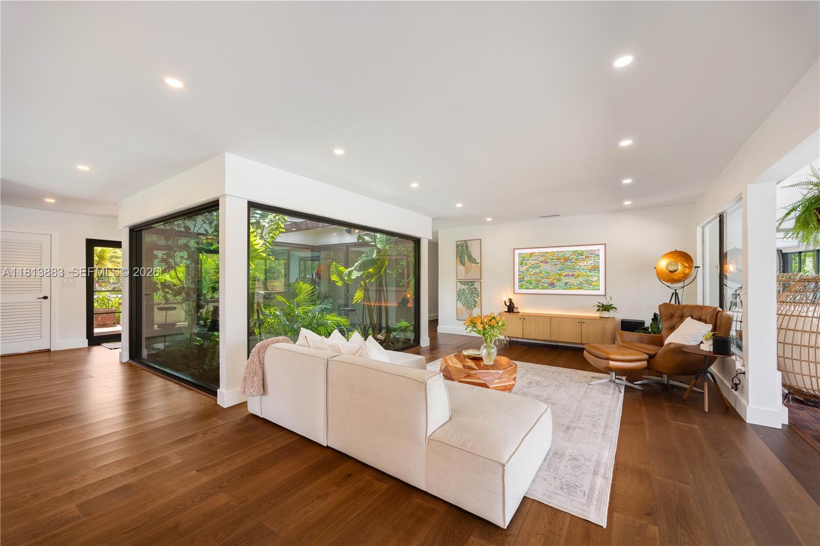 9670 Southwest 96th Court Miami, FL 33176 - Photo 11 of 45 a living room with furniture floor to ceiling window and wooden floor