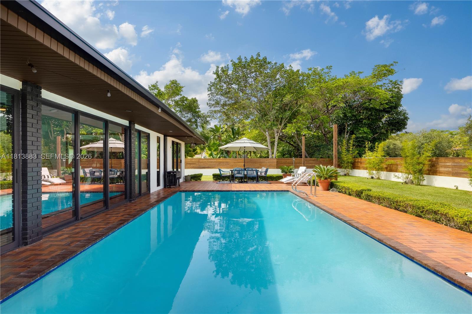 9670 Southwest 96th Court Miami, FL 33176 - Photo 33 of 45 a view of a swimming pool with a patio and a yard
