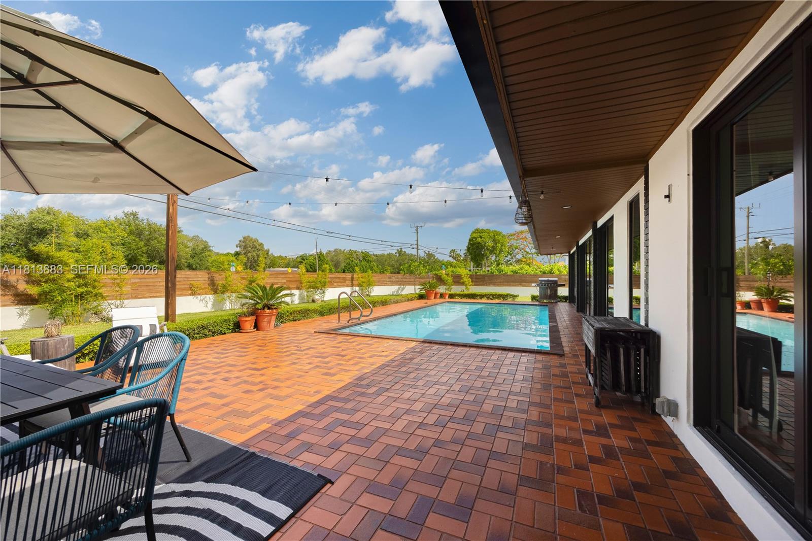 9670 Southwest 96th Court Miami, FL 33176 - Photo 35 of 45 a view of a patio with a table chairs and backyard