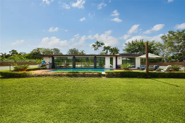 a front view of a house with a yard table and chairs