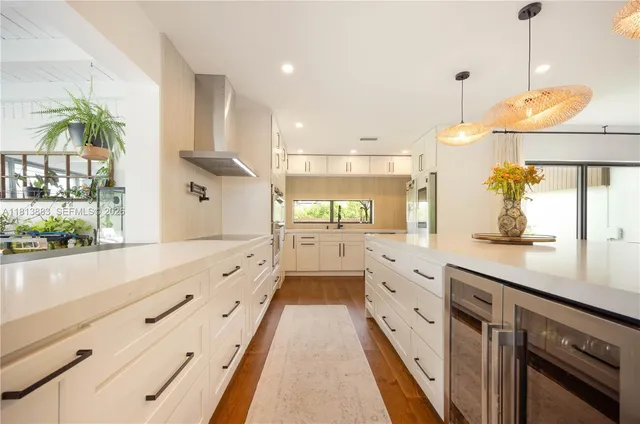 a living room with furniture and large windows
