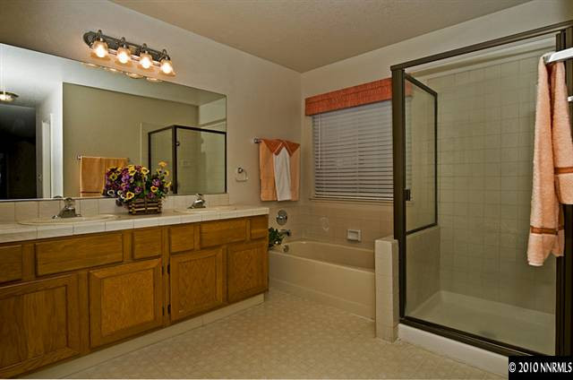 175 Lemming Drive Reno, NV 89523 - Photo 7 of 9 a bathroom with a double vanity sink mirror and shower