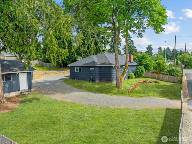 a front view of house with yard and trees