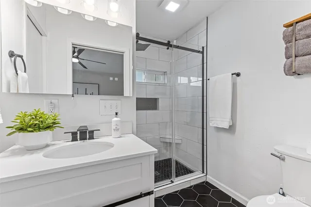 a bathroom with a sink toilet and shower