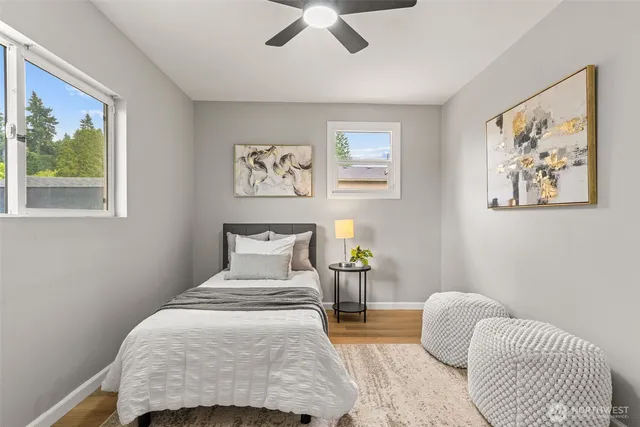 a bedroom with a bed and a painting on the wall