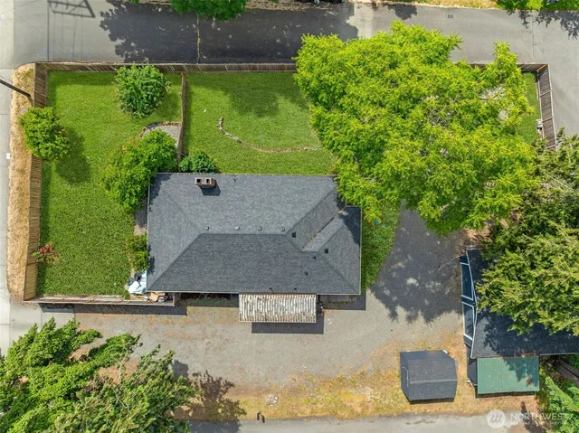 an aerial view of a house with a yard