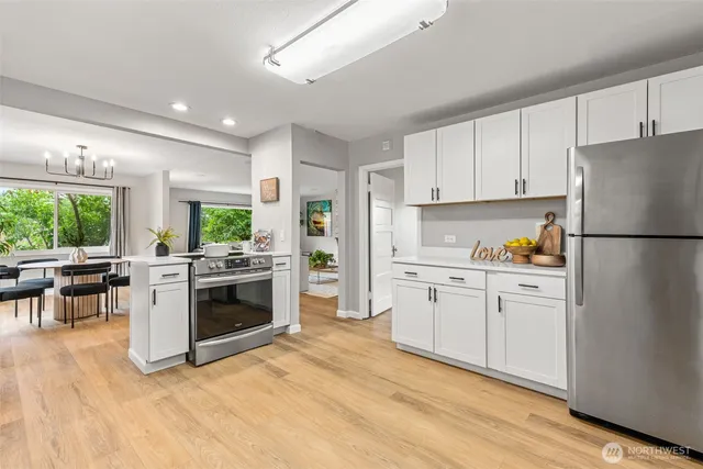 a kitchen with white cabinets and white appliances