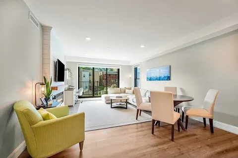 a living room with furniture wooden floor and a flat screen tv