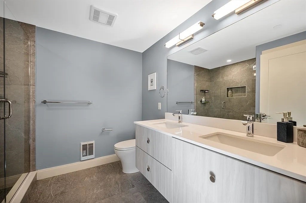 765 East 3rd Street, Unit 201 Boston, MA 02127 - Photo 5 of 10 a spacious bathroom with a double vanity sink toilet and a mirror