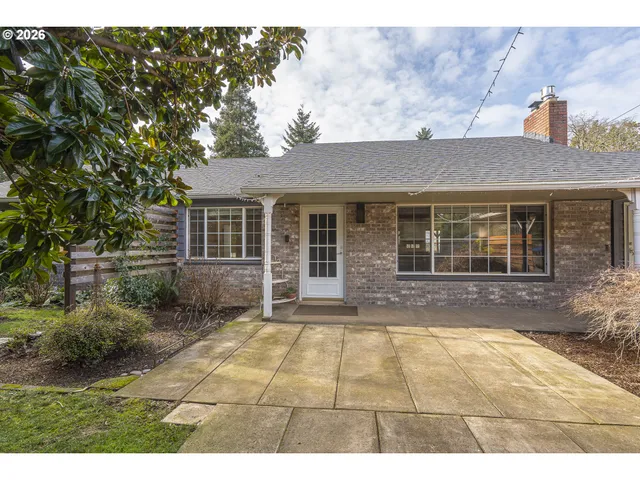 a front view of a house with a garden