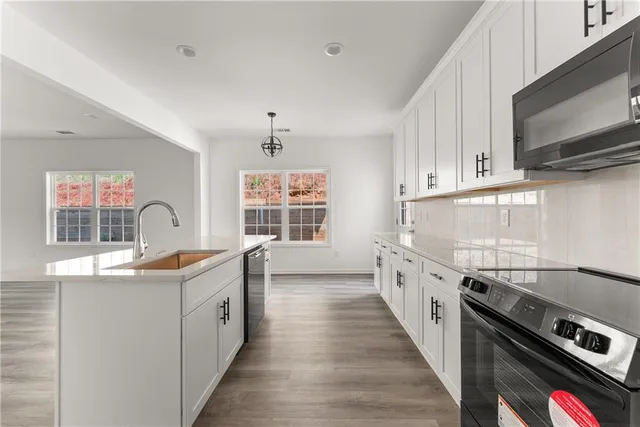 a kitchen with a sink a stove and a window