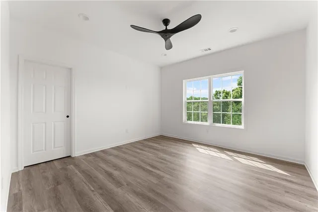 wooden floor in an empty room with a window