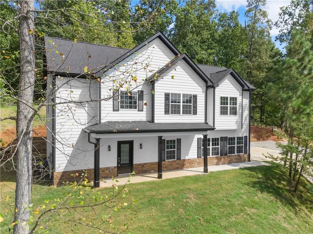 a front view of a house with a yard
