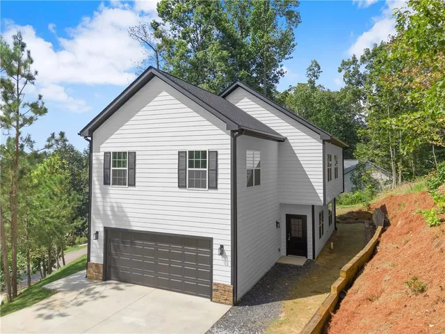 a view of house along with yard and trees