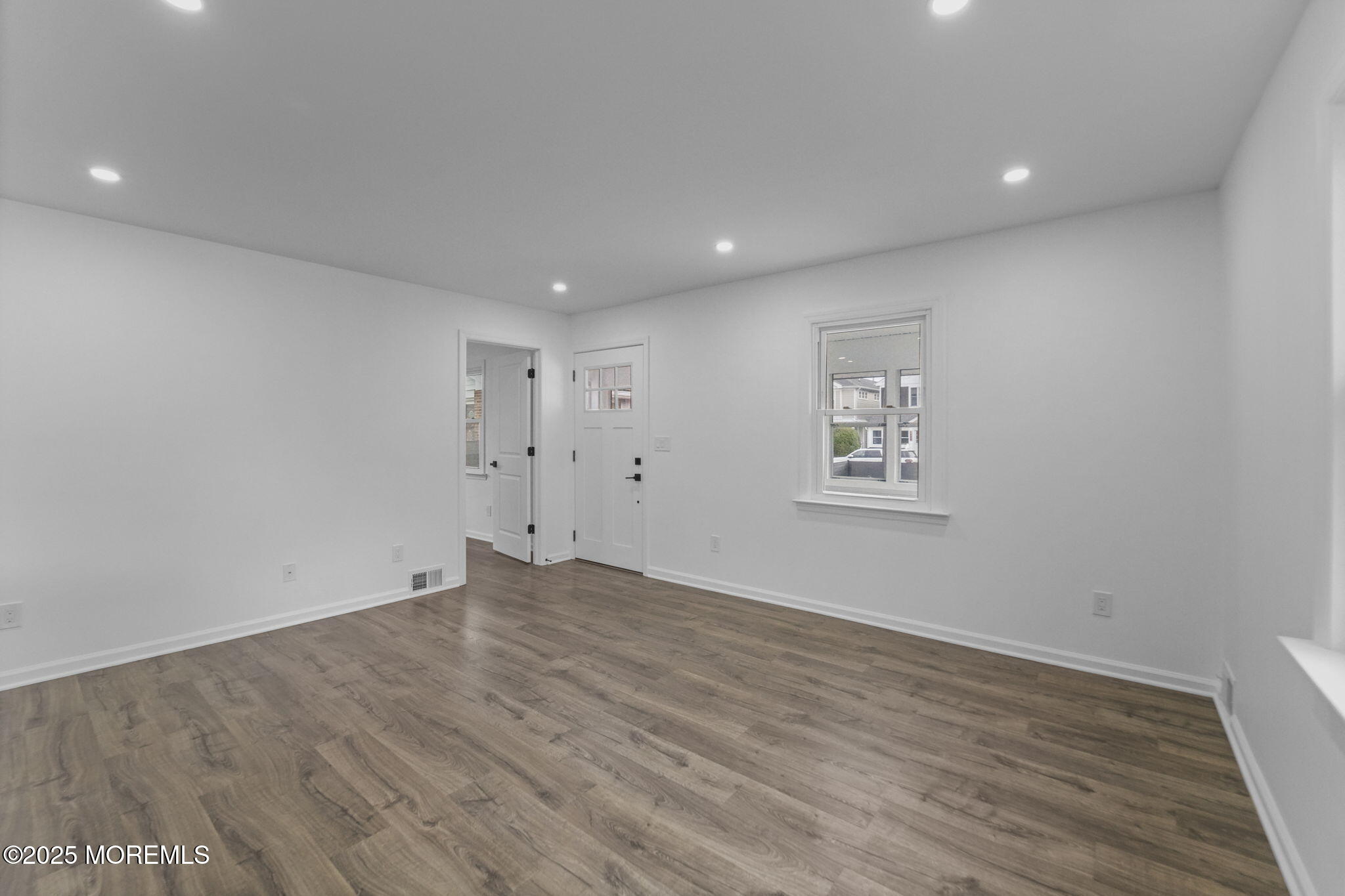 1807-1809 Laurel Terrace Belmar, NJ 07719 - Photo 4 of 20 an empty room with wooden floor and windows
