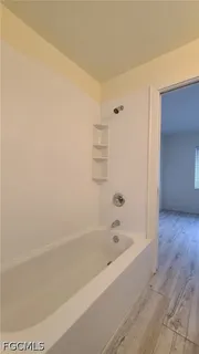 a bathroom with bathtub and shower