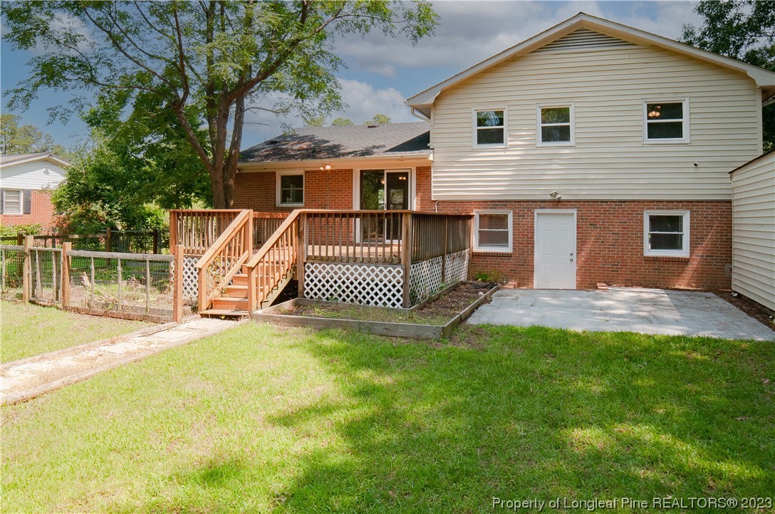 4605 Nix Road Fayetteville, NC 28314 - Photo 11 of 48 a view of a house with a patio and a yard