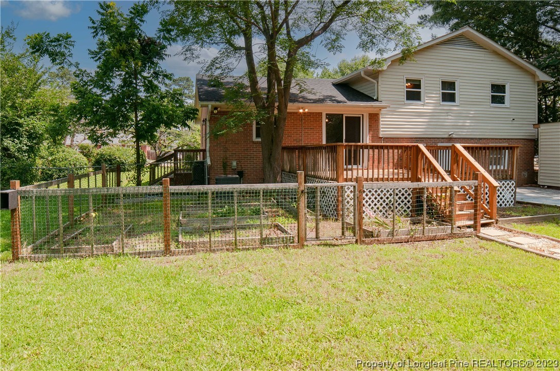 4605 Nix Road Fayetteville, NC 28314 - Photo 12 of 48 a view of a house with a backyard and a patio
