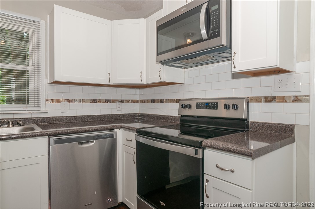 4605 Nix Road Fayetteville, NC 28314 - Photo 28 of 48 a kitchen with a stove microwave and sink