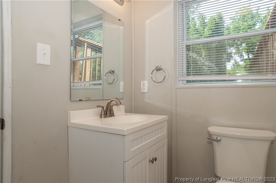 4605 Nix Road Fayetteville, NC 28314 - Photo 34 of 48 a bathroom with a sink a toilet and a window