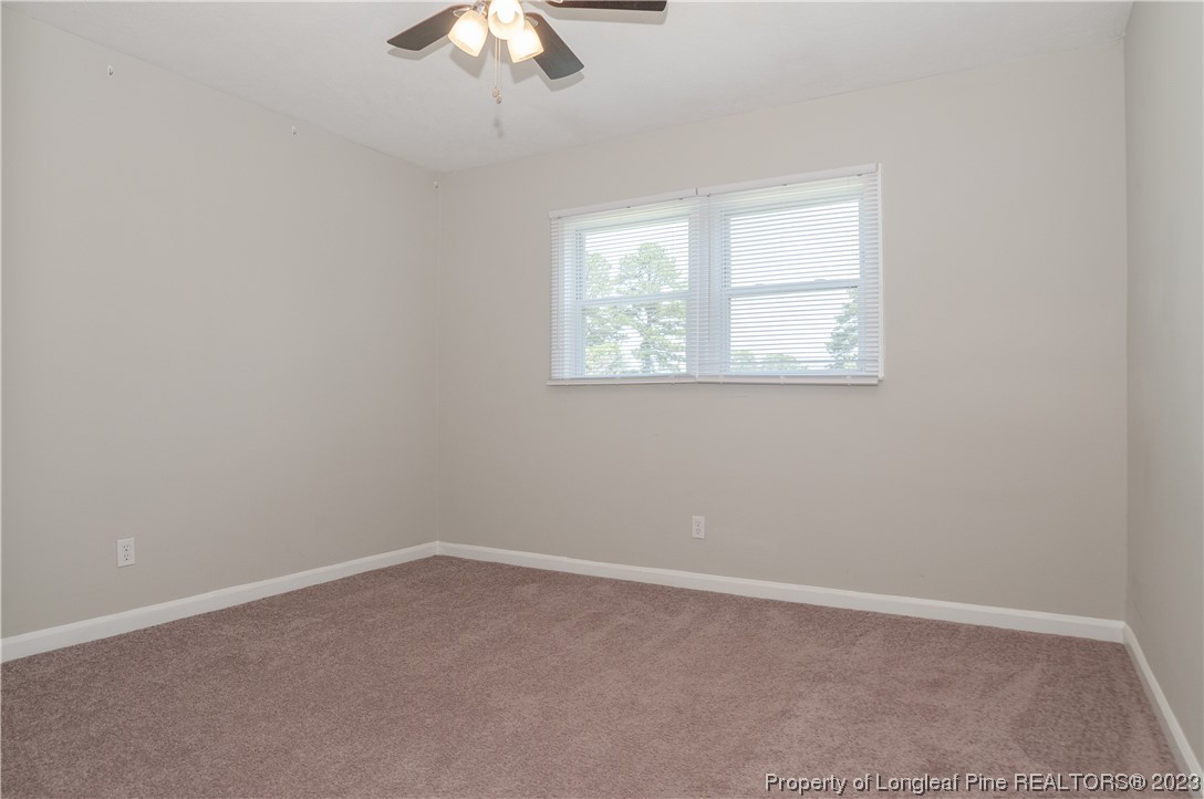 4605 Nix Road Fayetteville, NC 28314 - Photo 35 of 48 an empty room with a chandelier fan and windows