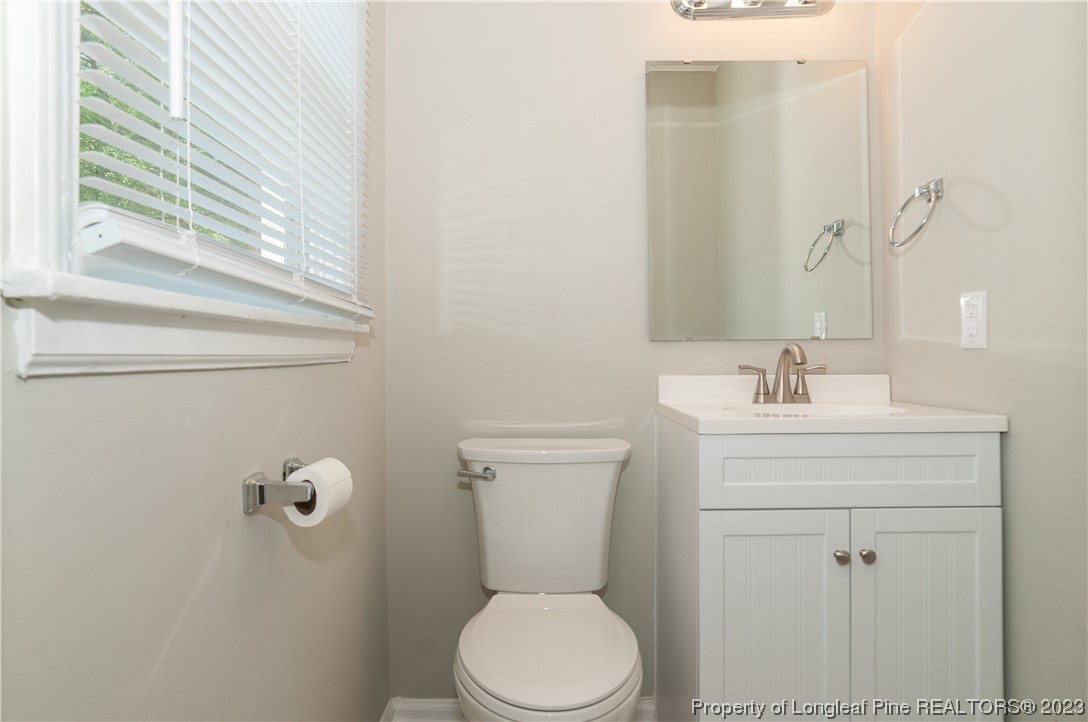 4605 Nix Road Fayetteville, NC 28314 - Photo 46 of 48 a bathroom with a sink a toilet and a mirror