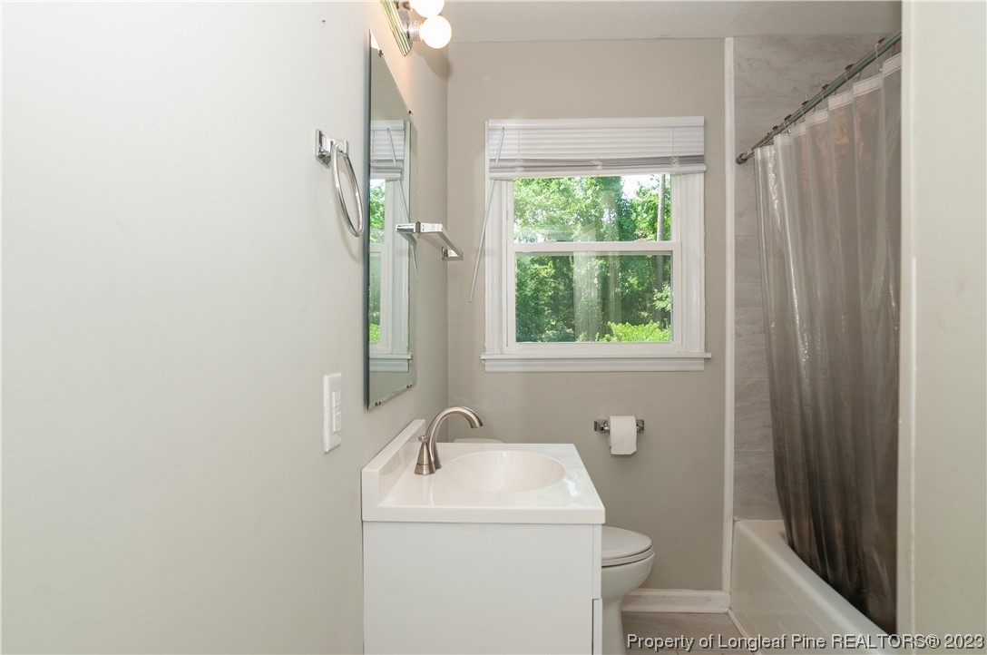 4605 Nix Road Fayetteville, NC 28314 - Photo 47 of 48 a bathroom with a sink a toilet and a mirror