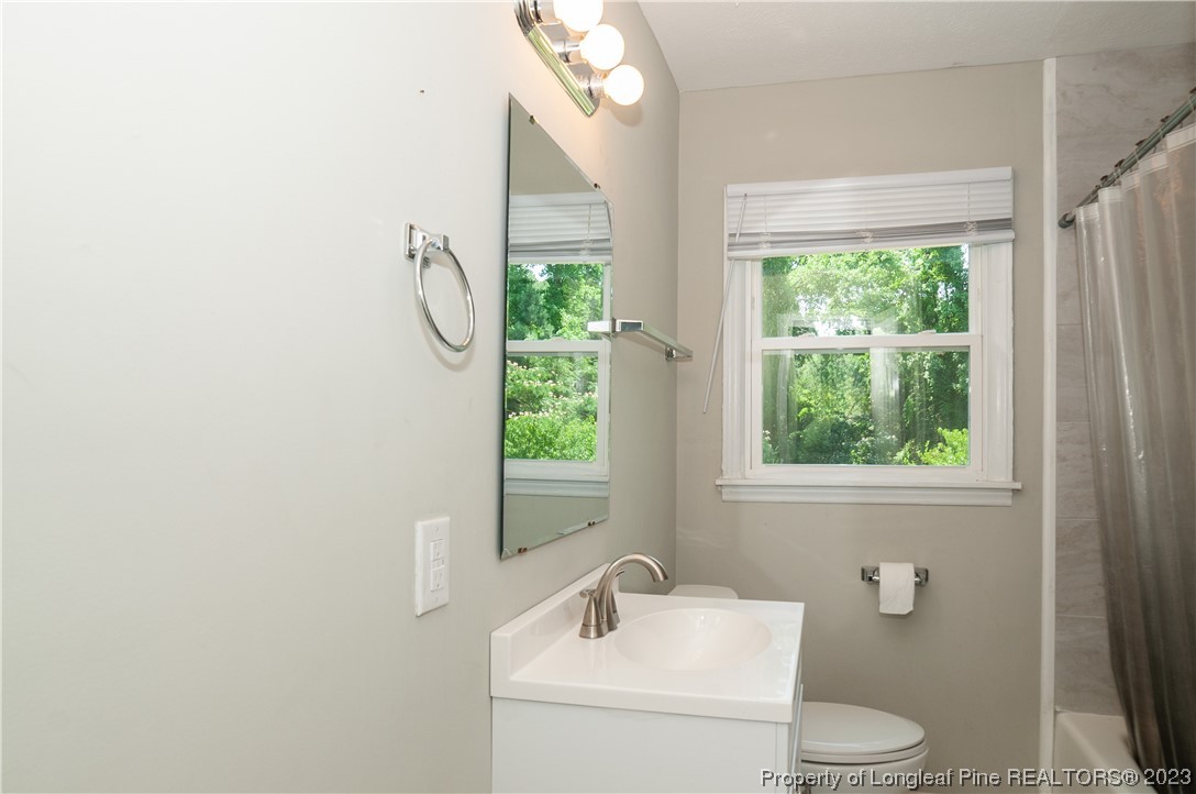 4605 Nix Road Fayetteville, NC 28314 - Photo 48 of 48 a bathroom with a sink toilet and window