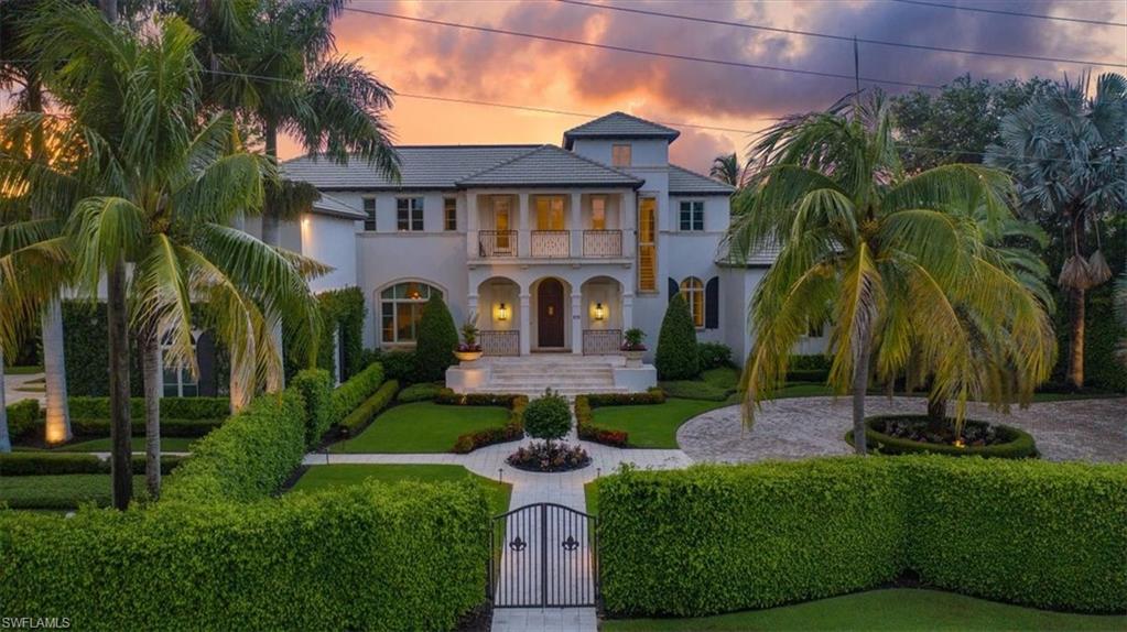 a view of a brick house with a yard and plants