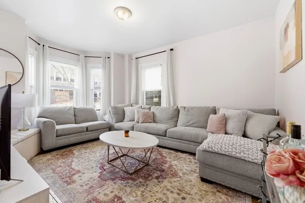 a living room with furniture and a large window