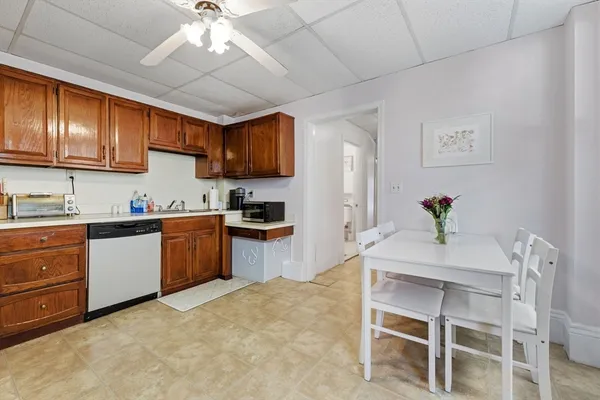 a kitchen with granite countertop a sink cabinets stainless steel appliances and a center island