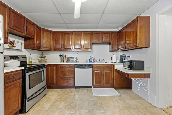 a kitchen with stainless steel appliances granite countertop granite top a stove top oven a sink dishwasher and cabinets