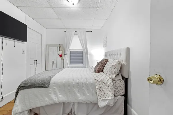 a bedroom with a bed and a flat screen tv