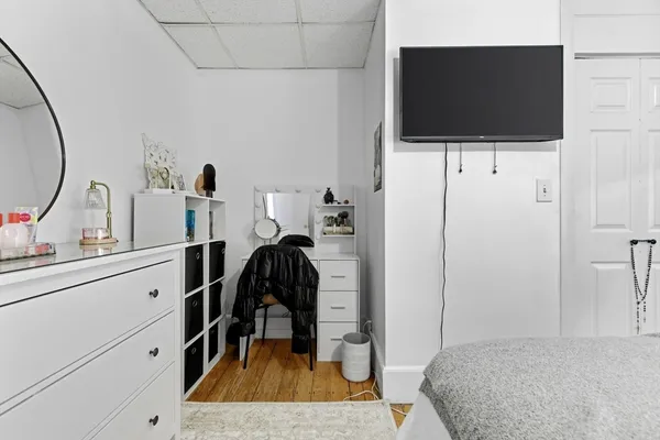 a view of a bedroom with a flat tv screen and a bathroom