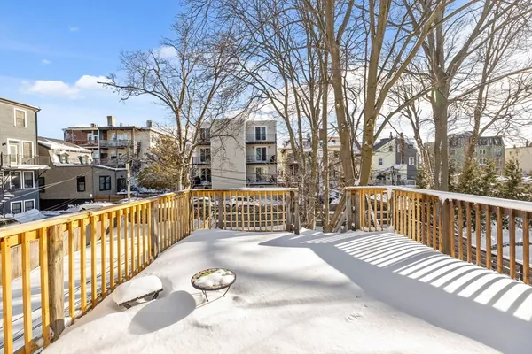 a view of a street with wooden fence
