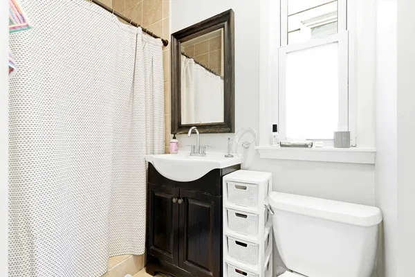 a bathroom with a sink toilet and mirror