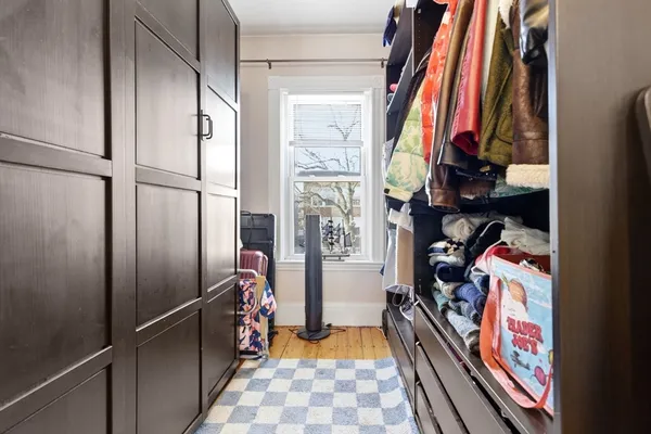 a view of walk in closet with clothes and shoes