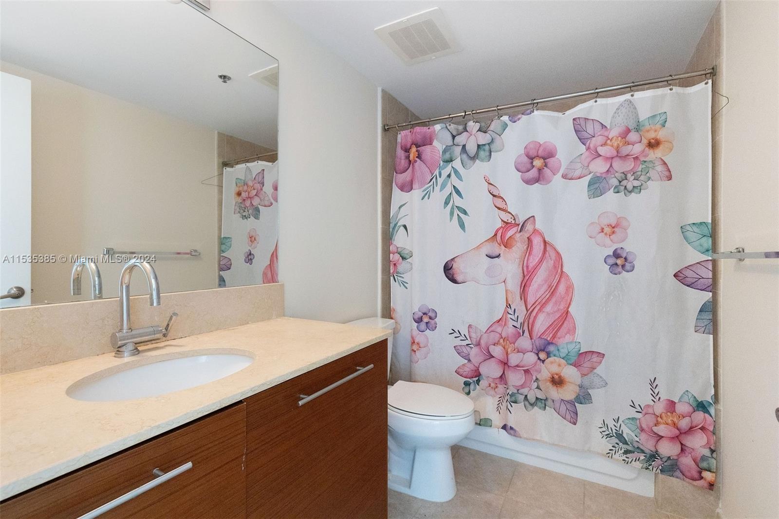 2681 North Flamingo Road, Unit 1405S Sunrise, FL 33323 - Photo 19 of 28 a bathroom with a sink mirror and toilet