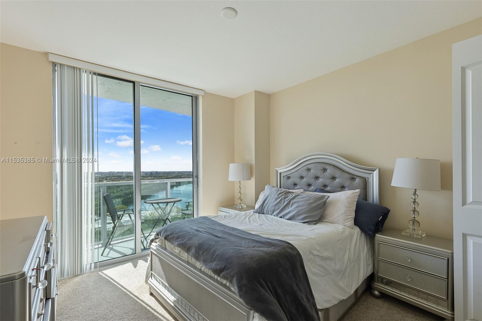 2681 North Flamingo Road, Unit 1405S Sunrise, FL 33323 - Photo 20 of 28 a bedroom with a large bed and a large window